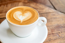 Close Up White Coffee Cup With Heart Shape Latte Art On Wood Tab