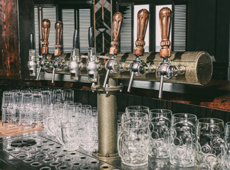 Wall Mural - Draft beer taps in modern bar