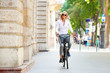 © sepy - She goes everywhere by bike. Full length shot of a young woman in the street with a bicycle.