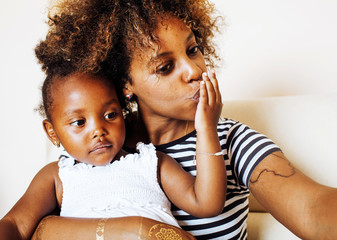 adorable sweet young afro-american mother with cute little daugh