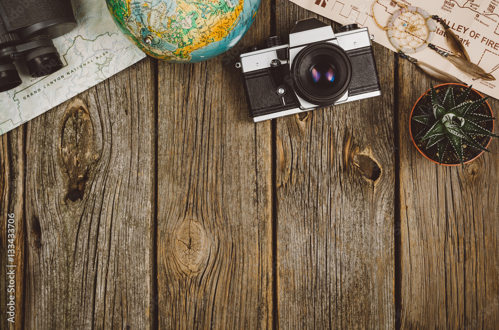 Accessories for travel top view on wooden background with copy space. Adventure and wanderlust concept image with travel accessories. Preparing for an exotic trip, journey and sightseeing. - obrazy, fototapety, plakaty 