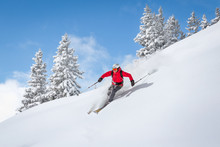 Freeride Skiier Riding In Deep Powder Snow