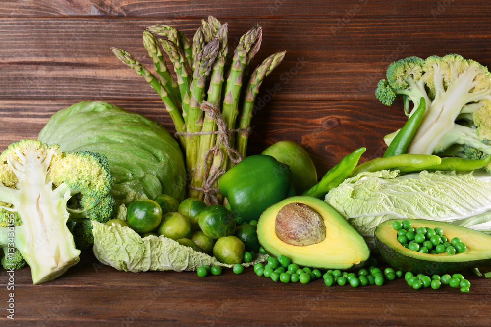 Green vegetables on wooden background