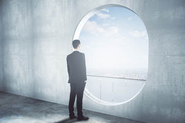 Wall Mural - Thoughtful businessman in concrete interior side