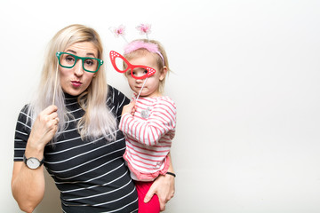 mom and daughter posing on white background party props wedding celebration happy booth