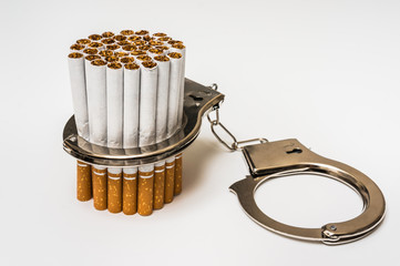 Cigarettes and handcuffs - smoking addiction concept