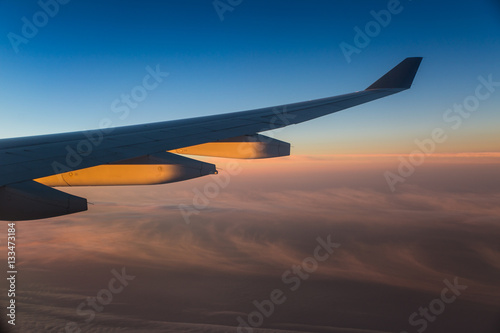 Fotografie, Obraz Sunrise on the wing of a plane and clouds