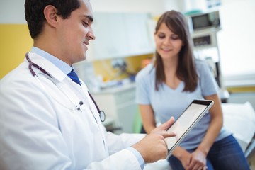 Poster - Doctor using digital tablet while consulting patient