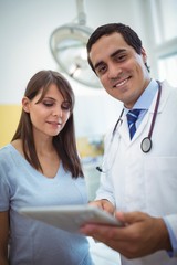 Poster - Doctor assisting female patient on digital tablet