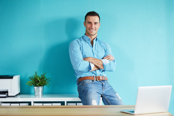 Wall Mural - Businessman leaning against a shelf