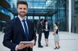 © WavebreakMediaMicro - Happy businessman holding digital tablet