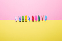 Clothespins In Line On Double Background In Minimalism