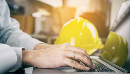 worker in Construction industry is working on computer.