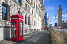 London, England - Traditional Red British Telephone Box With Big Ben And Double Decker Bus At The Background On A Sunny Afternoon With Blue Sky And Clouds