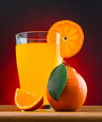 Wall Mural - orange juice in a glass on a table