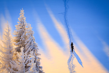 Two tourist walking in trail on the fresh snow in the morning light.