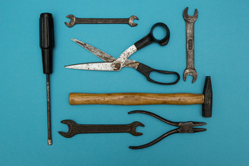 Set of old rusty tools on a blue background