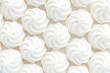 Closeup of mini meringues on white as food background.