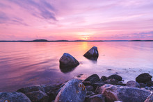 Violet Toning Sea Shore Landscape With Great Stones At Foreground. Location: Sweden, Europe.