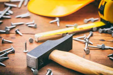 Wall Mural - Hammer and nails on wooden background