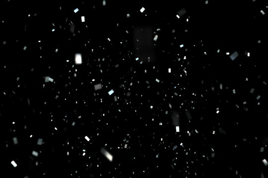 falling silver metallic glitter foil confetti, animation movement on black background, holiday and festive fun