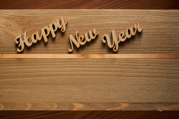 Happy New Year!/Happy New Year! - A phrase with wooden letters on a wooden backg