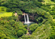 Stunning aerial view of Wailua Waterfall near the island capital Lihue on the island of Kauai, Hawaii. Wailua Falls is a 173 foot waterfall that feeds into the Wailua River. Seen from a helicopter.