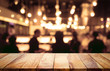 Empty wood table top on blur light bokeh in dark night party (cafe)