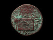 Ancient bronze roman coin isolated on black