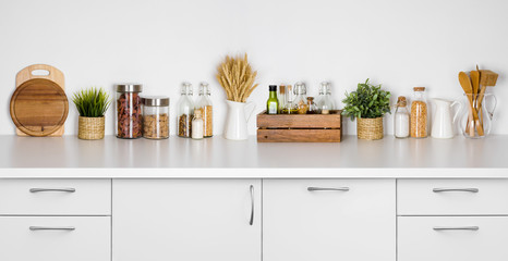 Kitchen bench shelf with various herbs, spices, utensils on white