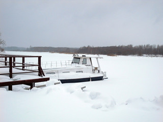 Russian Winter. The ship on the lake in the ice.