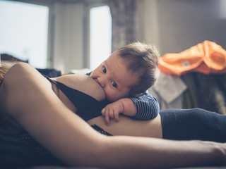 Wall Mural - Little baby breastfeeding in bed