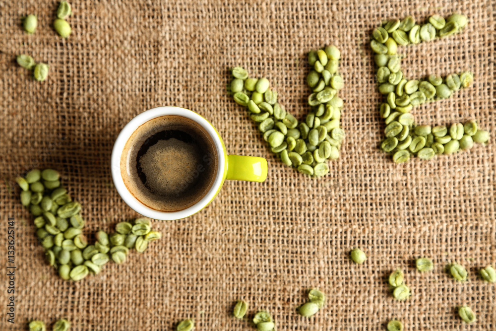 Cup of coffee with word LOVE on sackcloth