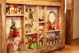 Fototapeta  - Details of the interior decoration of cafes, bars, room in shabby chic style. Bottle of wine, watches, plates, green banks, fork, post cards, viburnum, grater. Winter decor.