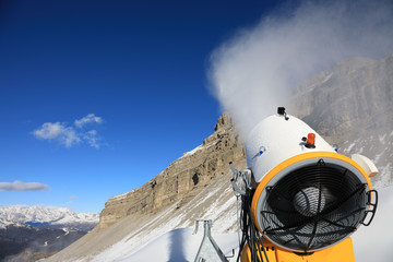 Snow cannon against the blue sky