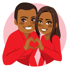 Sweet happy young African American couple making heart symbol joining hands on Valentine day