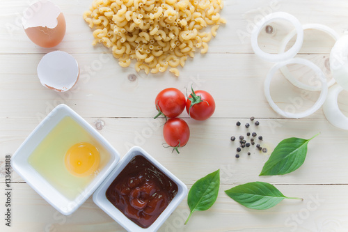 Stampe spaghetti with ingredients for cooking on wood background