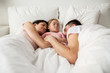 © Syda Productions - happy family sleeping in bed at home