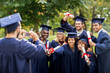 © Syda Productions - students or bachelors photographing by smartphone