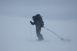 Ski touring man with sled in bad weather