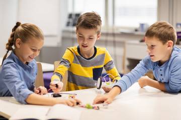 Wall Mural - happy children building robots at robotics school