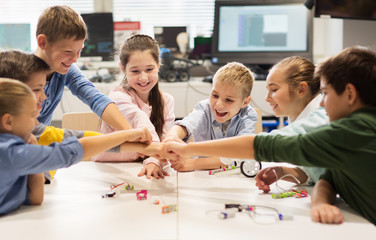 Wall Mural - happy children making fist bump at robotics school