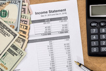 Save Money Concept - Doc Income Statement With Pen, Calculator And Money.