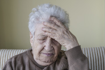 ill senior woman has headache