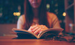 © estradaanton - woman reading a book in  cafe