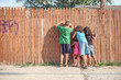 © soupstock - Kids peeking through a fence