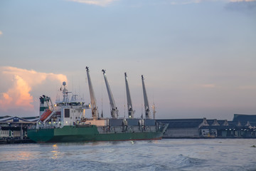 Logistic concept,Cargo ship docking port for loading up the boat to be sent to the next destination.