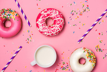 Donuts With Icing And Milk On Pastel Pink Background. Sweet Donu