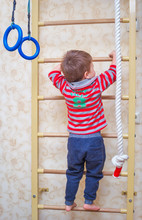 The Child Climbs Up The Stairs. Gymnastics Sports Swedish Wall