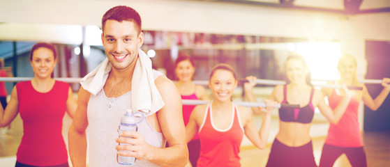 Canvas Print - smiling trainer in front of group of people